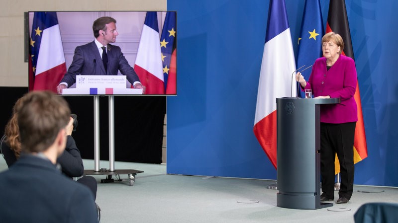 German Chancellor Angela Merkel and French President Emmanuel Macron hold a joint video news conference on Monday to propose a European Union coronavirus recovery fund of 500 billion euros. (Andreas Gora/Pool/Getty Images)